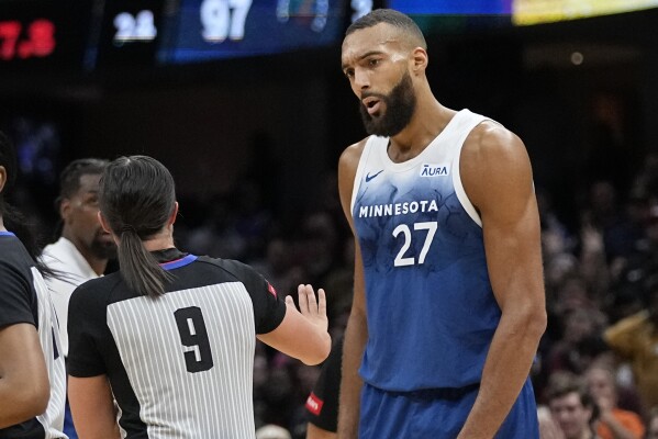 Timberwolves Rudy Gobert makes money sign at official and